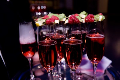 The evening's specialty cocktail was a mixture of champagne, brandy, and pomegranate juice, served with a kabob of raspberry and mint.
