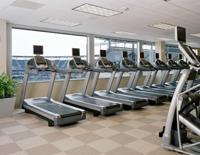 The hotel's fitness center features Precor equipment and floor-to-ceiling windows overlooking Camden Yards.