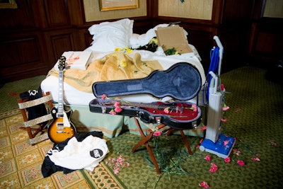 During the after-party, a fake punk band posed on a rumpled bed to evoke a wild night in a hotel. A model dressed as a maid pretended to vacuum up the mess.
