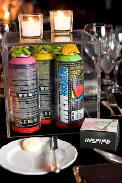 Planners worked the evening's hip-hop and graffiti-inspired look into the table decor by placing spray paint cans in Lucite cases along with the floral displays.