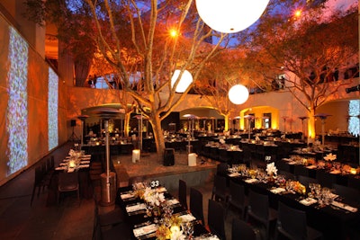 Illuminated spherical lanterns hung in the trees above the Hammer's courtyard, where the seated dinner took place.