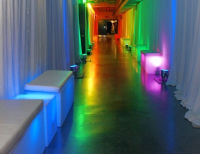 White pipe and drape, colored lights, and glow furniture transformed the arena's corridors into inviting foyers leading to the locker rooms-turned- private lounges.