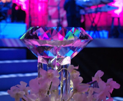 Sutka Productions created Lucite centerpieces of oversize diamond-shaped gems surrounded by white orchids at the base.