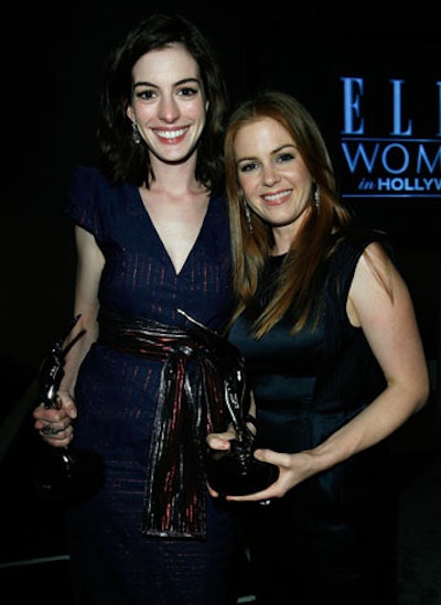 Anne Hathaway and Isla Fisher posed with their awards.