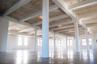 The sixth-floor gallery is a flexible 7,500-square-foot space with white columns and large windows.