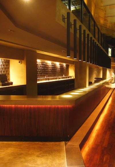 Vertical lighting fixtures illuminate one of the venue's bars.