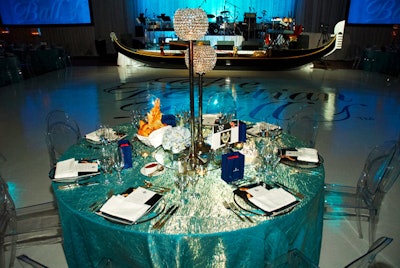 Crystal candleholders and small arrangements of blue hydrangeas topped tables throughout the room.