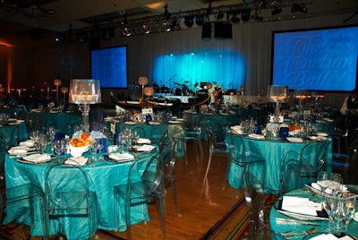 Eventure Custom Environments draped the ballroom in white, and Forget Me Knot Flowers used blue and silver decor to highlight the event's water theme.