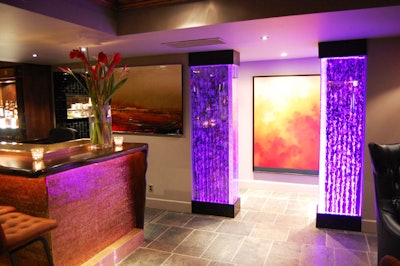 Two pillars filled with bubbling water are lit with LED lighting, which can be changed to reflect corporate colours for private events.