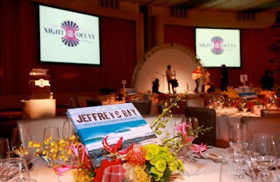 Flowers surrounding coffee table books featuring pictures of surfing locations served as centerpieces. (Life Rolls On offers an adaptive surfing program for people with spinal cord injuries.)