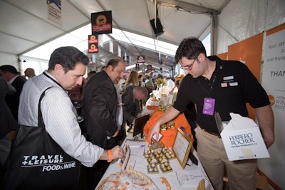 The Grand Tasting tent at Pier 54 featured almost 60 restaurants over its two days, as well as festival co-beneficiary Food Bank For New York City's booth, pictured here with special events manager Nicholas Ferrando (right).