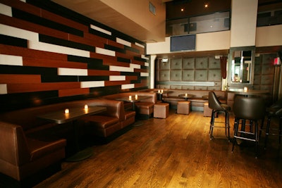 Chocolate brown banquettes and wood paneling give the venue a neutral color palette.
