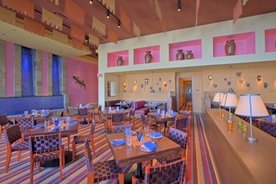 A distinctive design scheme featuring chairs made from seat belts, Mexican artwork, and blue and pink accents pervades the National Harbor restaurant.
