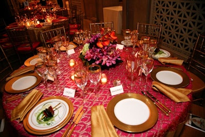 Striped Indian cloths, gold-toned sheers, and gilded dinnerware covered the 20 round dinner tables.