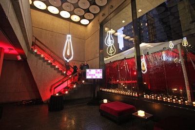 Red uplighting, candles, and the neon lightbulbs accented the studio party space.