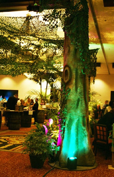 Faux tree trunks served as supports for the camouflage-netting canopy above sponsors' tables.