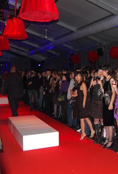 Red lampshade-shaped lights and feather topiaries decorated the cocktail reception, held in the tent that housed the main runway during L'Oréal Fashion Week.