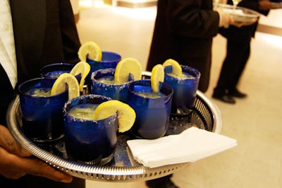 The evening's specialty cocktail was a salt-rimmed margarita served in a dark blue glass.