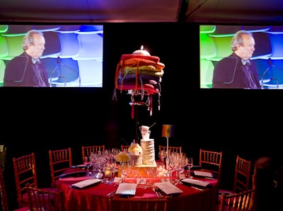 Levitating seat-cushion chandeliers used every color of the rainbow, but the cushions on the chairs were uniform at every table.