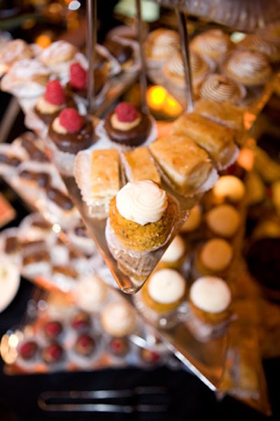 A dessert buffet offered treats such as bite-sized lemon meringue tarts and chocolate truffles dusted with cocoa powder.