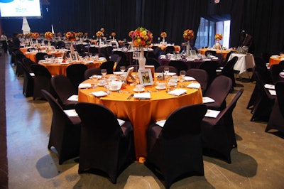 Organizers divided the room into two colour schemes with dining tables dressed in orange and black, and black and white.