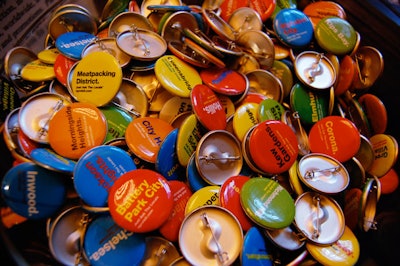 A table filled with NYC & Company's line of neighborhood buttons from the five boroughs let guests show off their local affiliations.