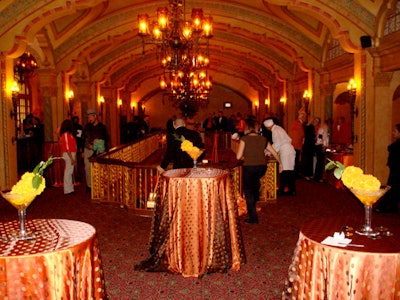 2Taste Catering used rust-colored linens and orange accents to decorate the theater lobby.