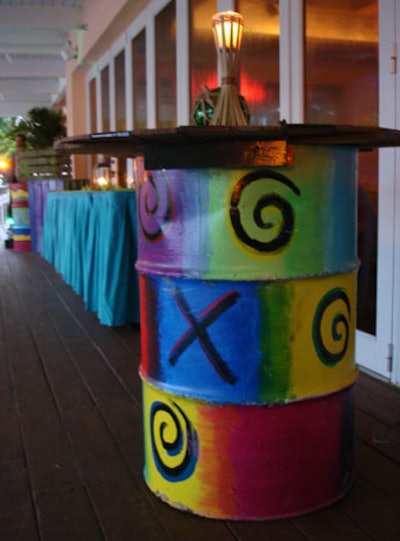 Tall painted oil barrels served as cocktail tables outside.