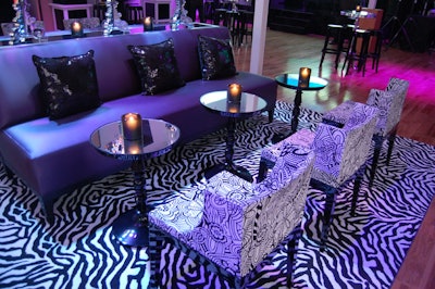 Event decor included purple couches, mirror-topped cocktail tables, and zebra print carpets.