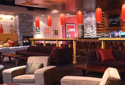 The private wine room in Lucky Strike Lanes offers plush seating, a separate bar, and a fireplace.