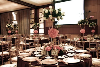 Tables were decorated in hues of plum and gold, with peacock-feather- and rose-adorned centerpieces.