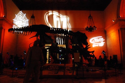 Logo gobos shone on the walls behind the dinosaur bones in the foyer.