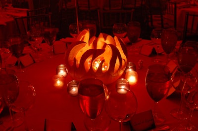 Carved pumpkins provided an eerie glow to tabletops in the dimly lit room.