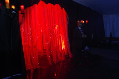 The corridor between the cocktail and dining tents had wind and smoke machines to swirl the hundreds of spidery red ribbons hanging from the ceiling.
