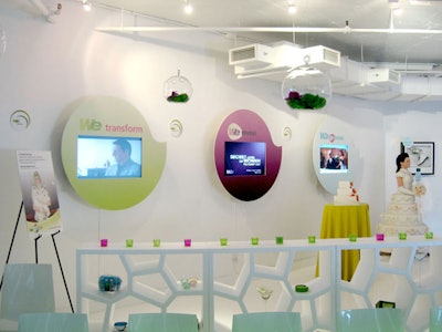 Plasma screens on the walls displayed videos from WE TV shows, and white divider shelves held branded premiums.