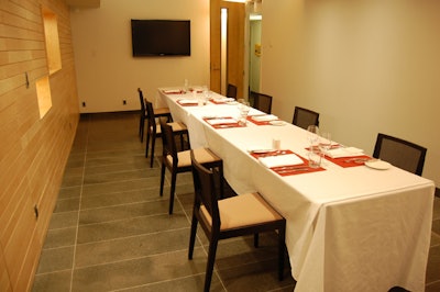 Oak-paneled walls furnish the simple downstairs private dining room.