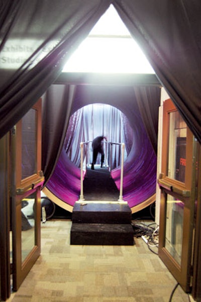At the Ontario Science Centre's Innovators' Ball in Toronto, a circular black walkway served as a tunnel linking a lounge to the dining space.