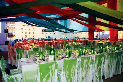 Van Wyck & Van Wyck crisscrossed 3,000 yards of blue, red, and green silk strips above the dinner tables for a New York benefit for arts nonprofit Studio in a School.