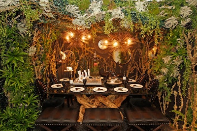 Branches, moss, and wooden blackbirds resting on each plate created a Gothic-forest vibe in Kara Mann Designs' dining environment.