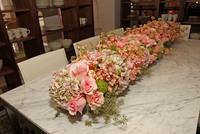 Pink roses and artichokes appeared in the tightly packed arrangement on Room and Board's table.