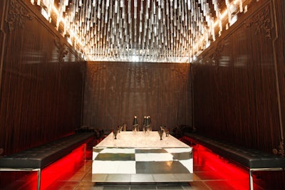 David Rockwell Group's table for Elit by Stolichnaya mixed old-fashioned carved-wood walls with modern crystal lights and a mirrored table.