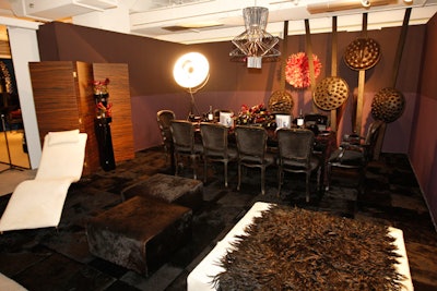 In Jennifer Sweas's dining environment for CS Interiors, a dark wood room divider complemented the installation's black and aubergine hues.