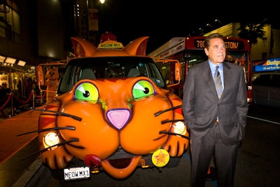 Chuck Woolery arrived at the party in a bright orange Meow Mix-logoed vehicle.