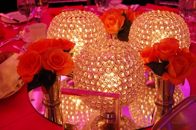 Karen Gruson worked with Frank Rea of Forget Me Not Flowers to create centerpieces of orange roses and crystal candleholders.