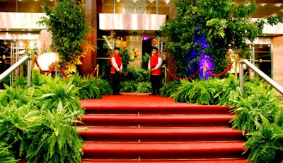 The steps of the hotel were lined with ferns and other foliage.