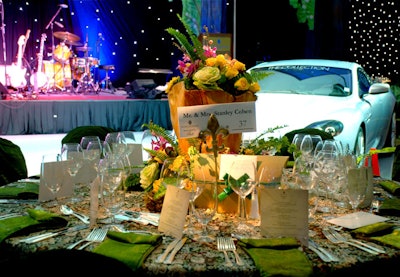 Abundant centerpieces of a variety of lilac, yellow, orange, and pink flowers topped the tables.