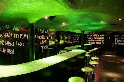Behind the bar, hollowed-out amps hold bottles.
