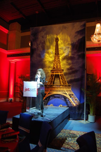 A poster of the Eiffel Tower provided a backdrop for the podium in the Paris-themed dining area.