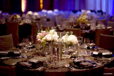 Jason Frix created simple centerpieces of cymbidium orchids and soft-colored roses surrounded by candlelight.
