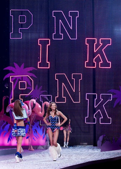 Throughout the show, decor elements such as oversize butterflies and bright pink lighting spelling out 'PINK' were added, and later removed, to further accentuate the collection on parade.